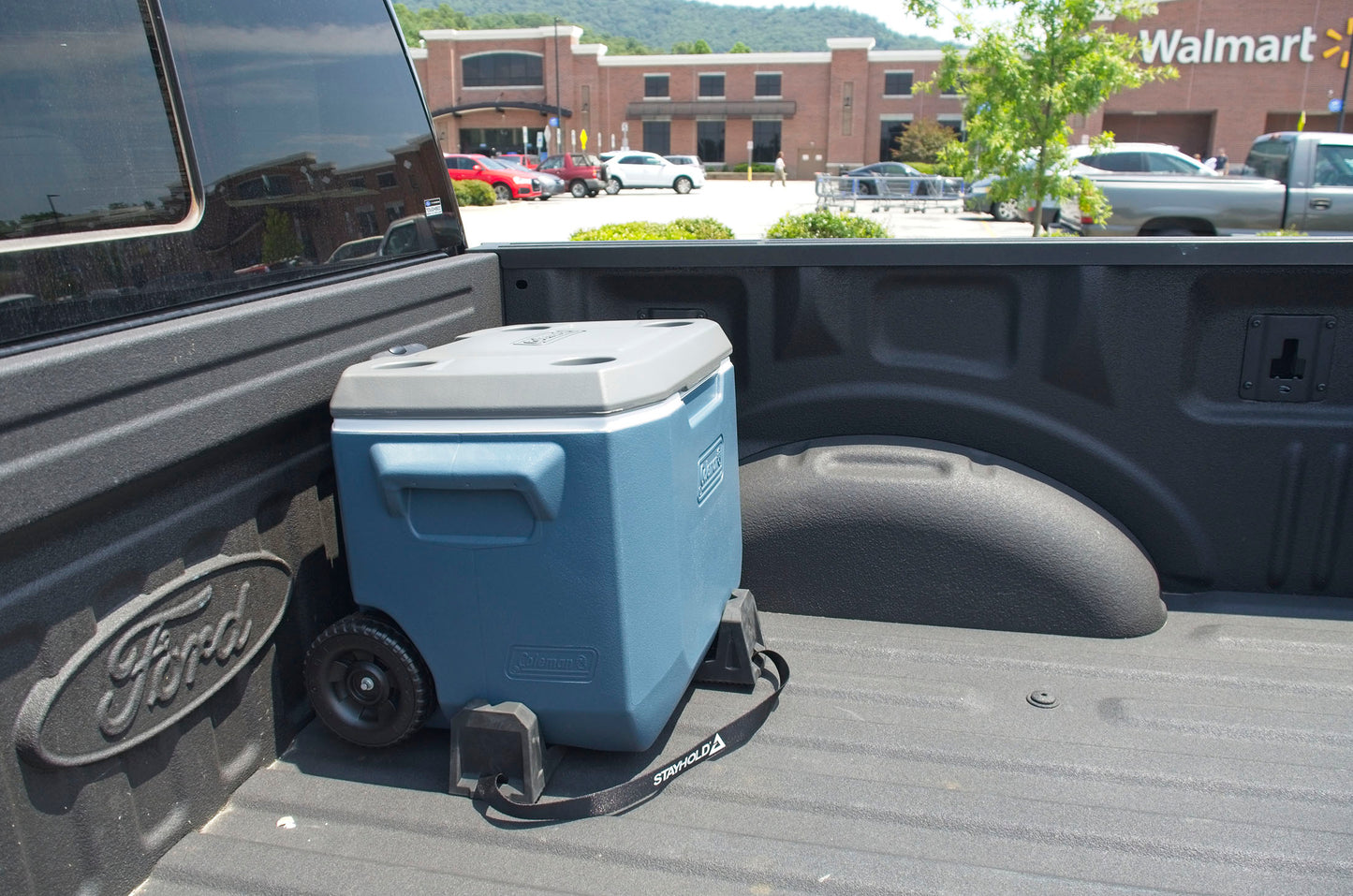 Stayhold CARGO WEDGE 2-PACK + TETHER. (Solid Rubber Cargo Chocks) holding a cooler