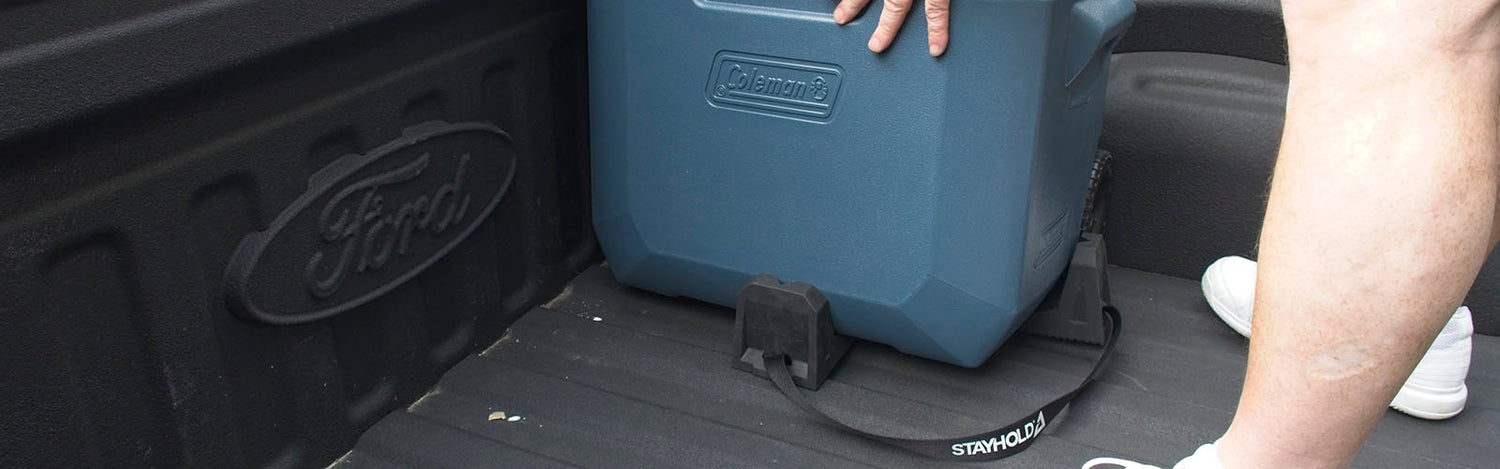 Stayhold cargo holders in a pickup truck securing a cooler box in the bed to stop is sliding around.